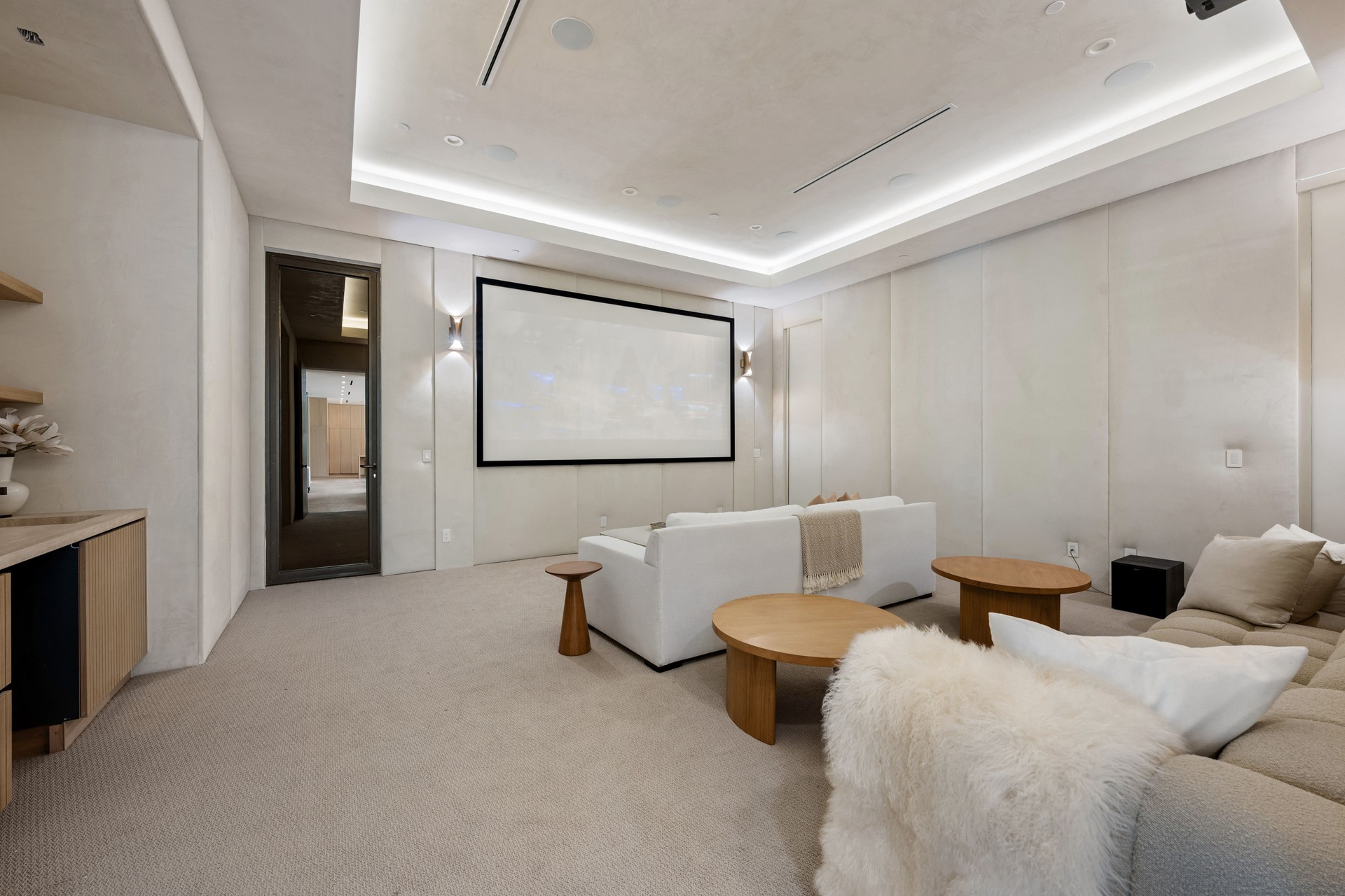 Luxurious modern home theater room with neutral tones.